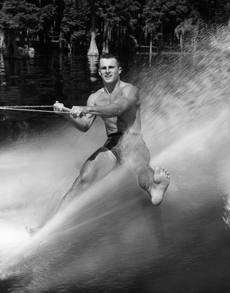 #141 Mike Osborn demonstrates his technique of water-skiing on the ball of one foot at Cypress Gardens, Florida, 1965