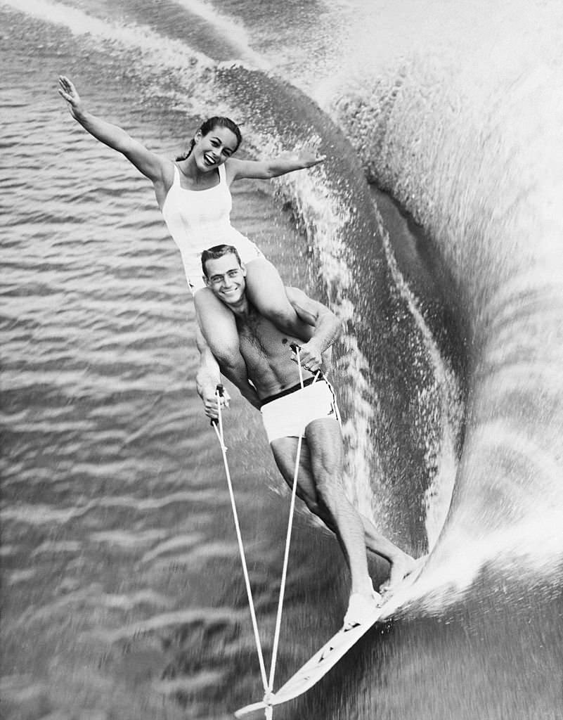 #180 lara Marquis rides on the shoulders of fellow water skier Jim Boyd in a show at Cypress Gardens, Florida.