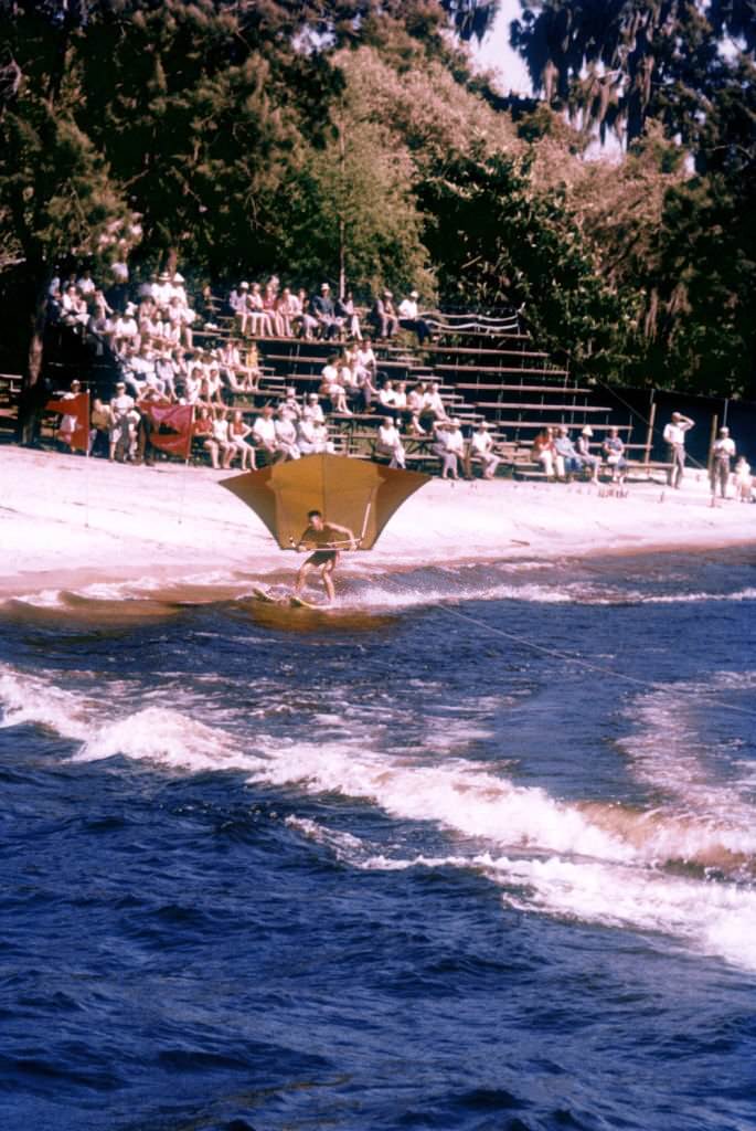 #4 A small crowd watches an unidentified man water ski near the shoreline circa 1958 in Cypress Gardens, Florida.