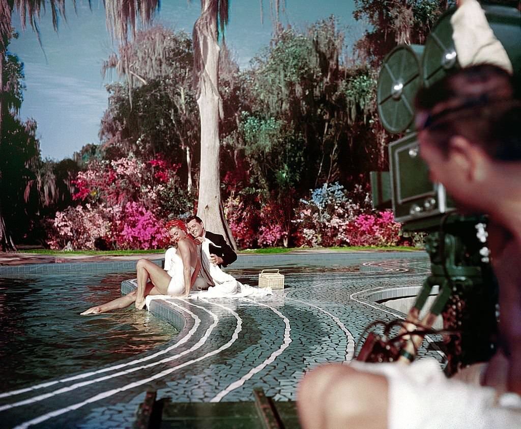 #74 Aquatic film star Esther Williams and singer/actor Tony Martin perform during the filming of ‘Easy To Love’ at Cypress Gardens theme park in 1953 near Winterhaven, Florida.