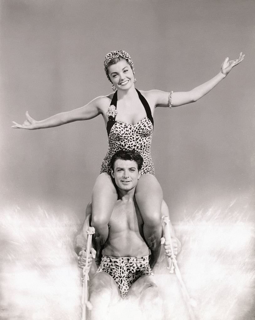 #88 Ski Team. Esther Williams sits atop John Bromfield’s shoulders to water-ski for movie ‘Easy to Love’.