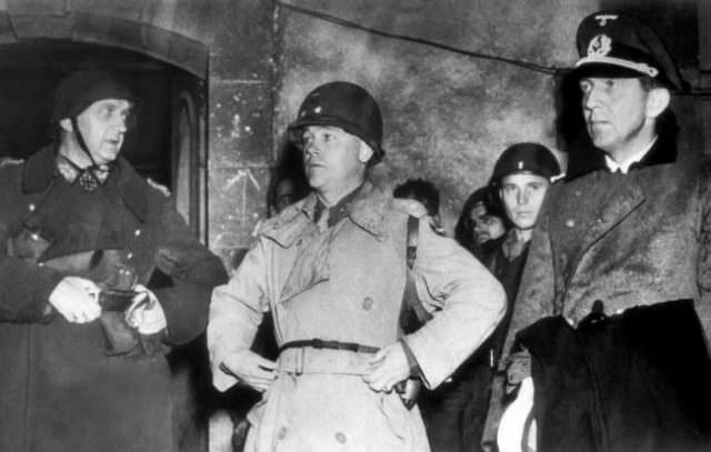 #35 Commander of the German forces which capitulated at the French port of Cherbourg, France, stand with their conqueror on June 30, 1944, after giving up the fight.