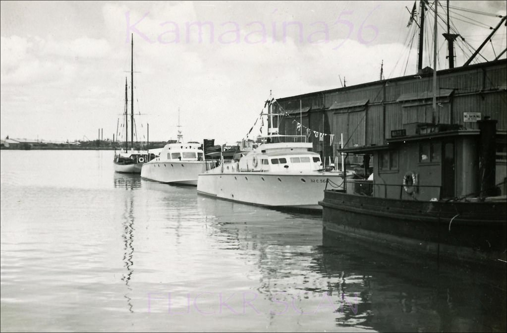 #35 Power boats moored in Honolulu Harbor with Sand Island in the distance, 1949