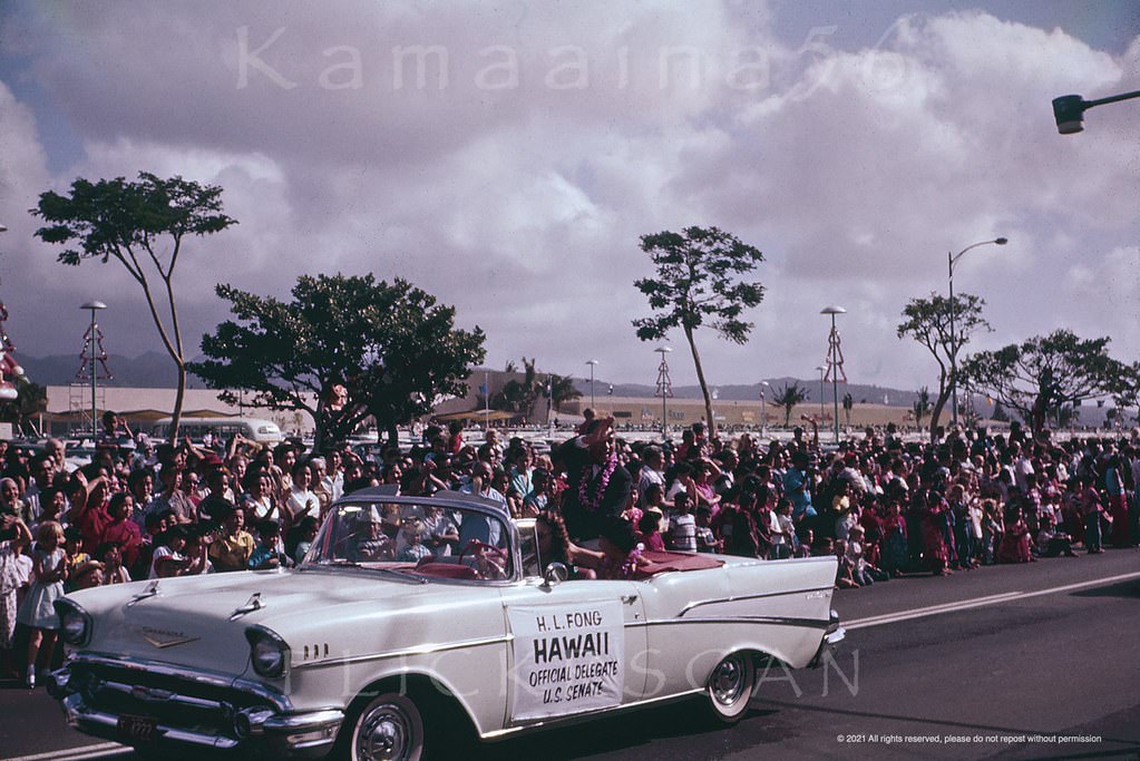#111 Long time Honolulu businessman and Republican Senator Hiram L. Fong (1906-2004) in a Christmas parade with Ala Moana Center in the background, 1959