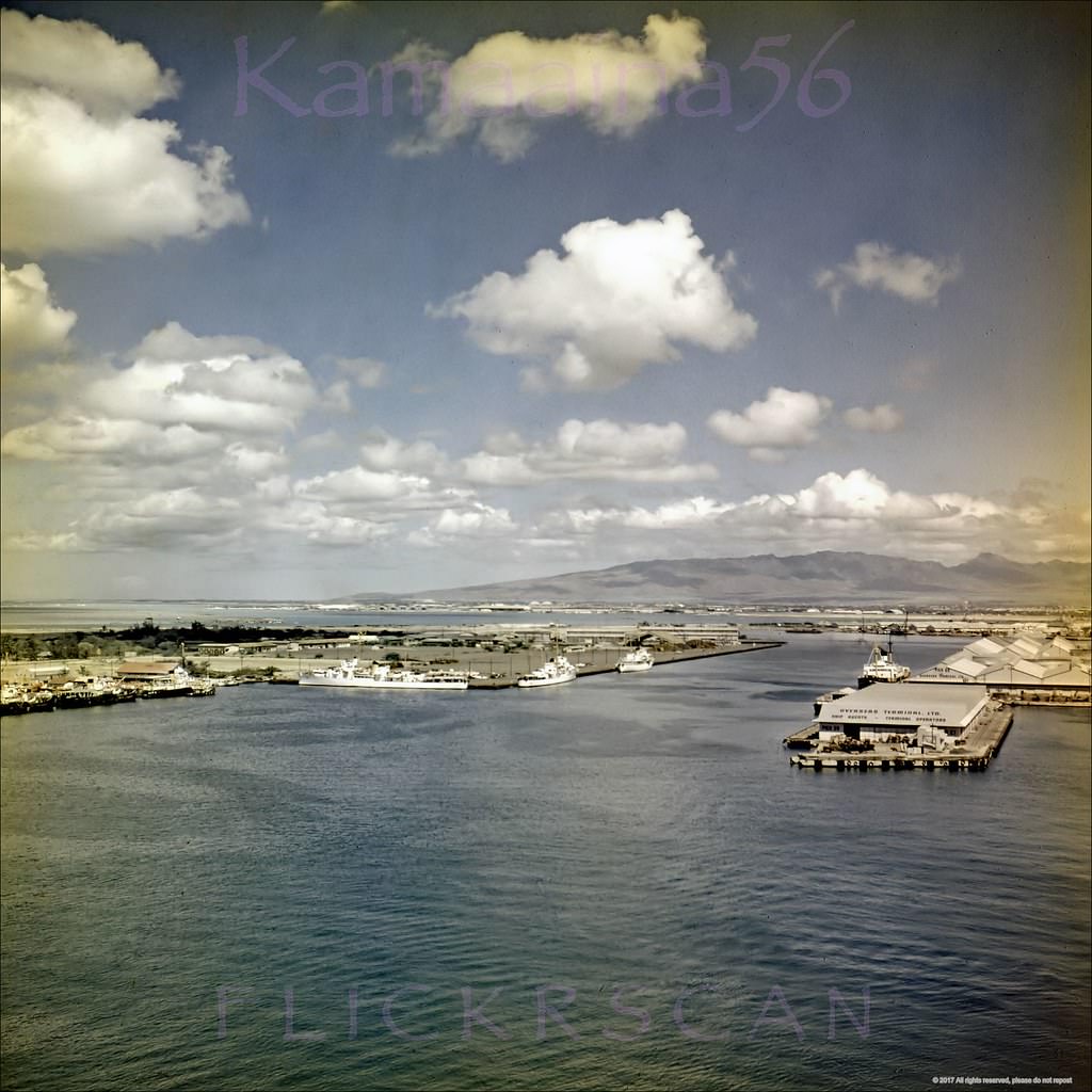 #144 Birdseye view of Honolulu Harbor and Sand Island looking west from the observation deck of the 10-story 1926 Aloha Tower, 1950s