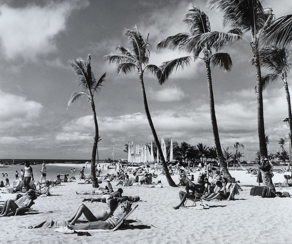 #3 A packed beach with people sunbathing and enjoying the sea, 1970s