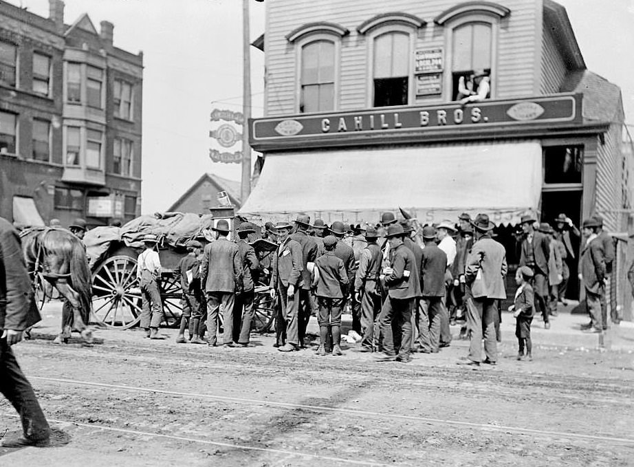#128 Men gathered outside the Cahill Brothers store, during a stock yard strike in the Halsted street area, Chicago, 1904.