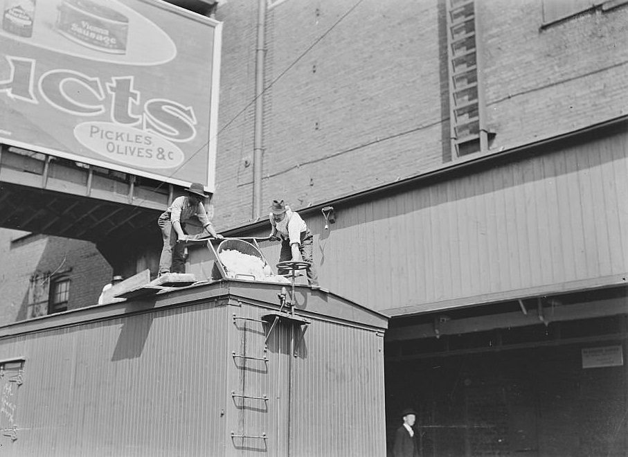 #215 Men pouring ice into the top of a train car during the 1904 Stockyards Strike, Chicago, Illinois, 1900s.