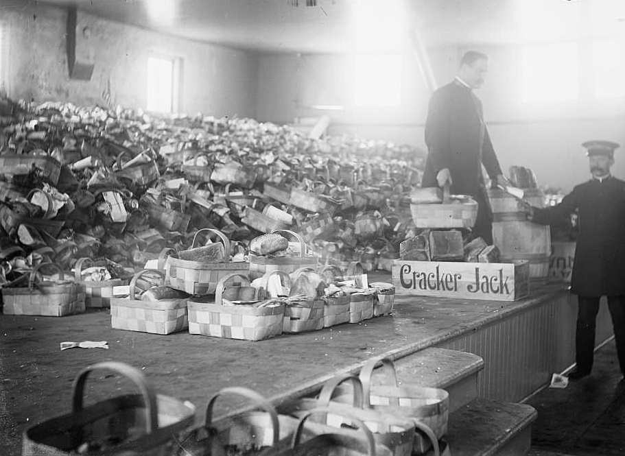 #217 View of Salvation Army food baskets piled up on a stage at Christmas, Chicago, Illinois, 1900s.