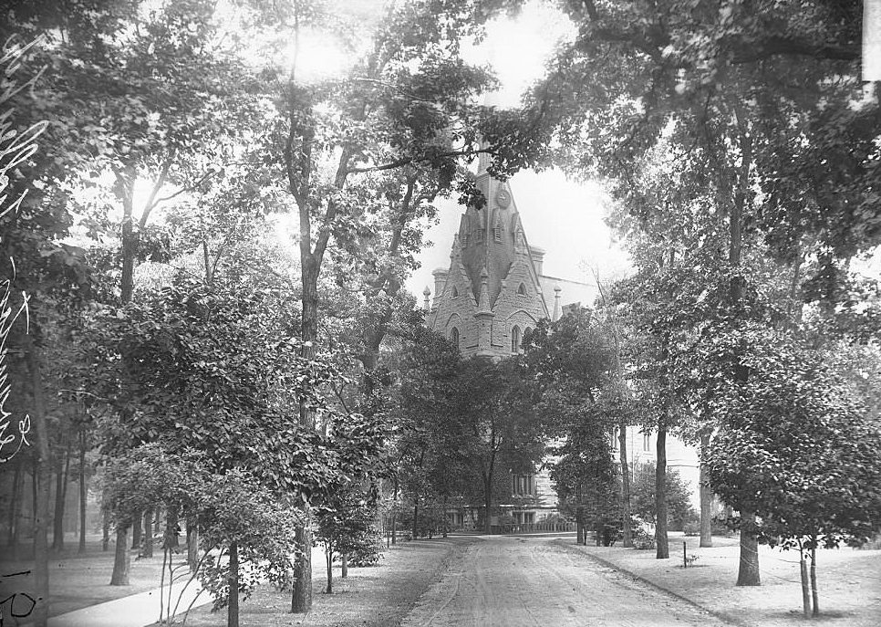 #223 Exterior view of University Hall at Northwestern University, looking down a path leading toward the building, Evanston, Illinois, 1900s.