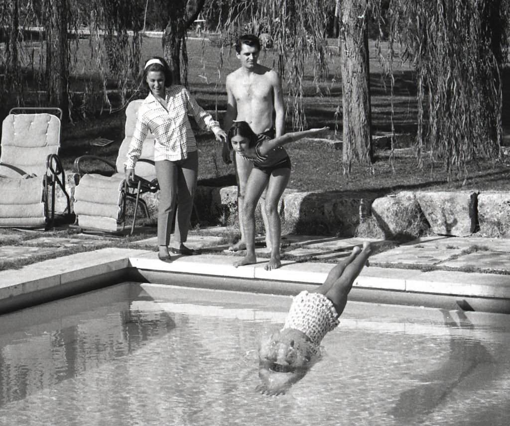 #188 Linda Christian at home of La Moraleja with her husband Edmund Purdom and daughters Romina and Taryn, Madrid, Spain, 1964.