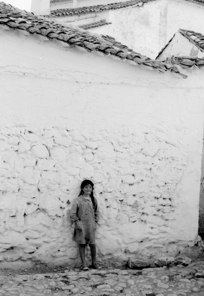 #231 Lonely girl leaning against a wall in El Toboso, Castilla La Mancha, Spain, 1962.