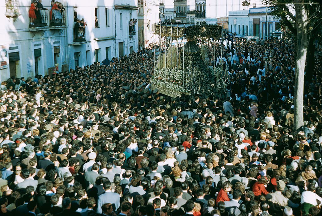 #71 A crowded street procession probably in Spain, 1960.