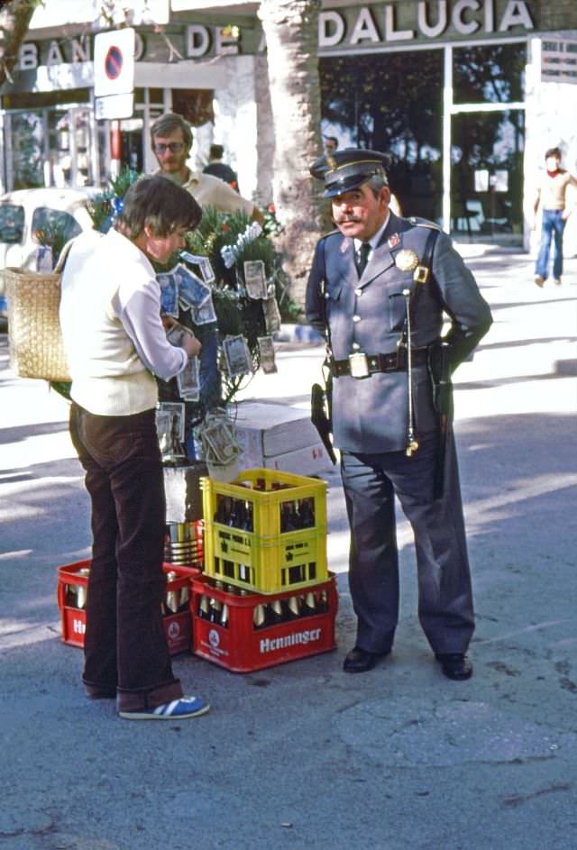 #230 Money on the Christmas tree and beer in plastic crates are gifts to local policeman, Almuñécar, 1977