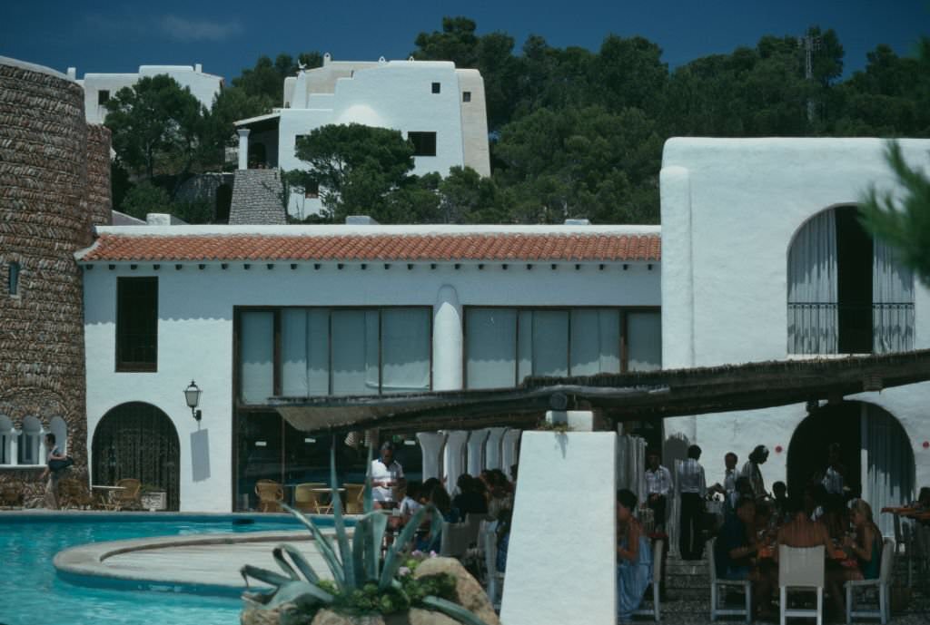 #89 Dinera on a poolside terrace at the Hacienda Na Xamena hotel in Port de Sant Miguel, Ibiza, Spain, 1978.