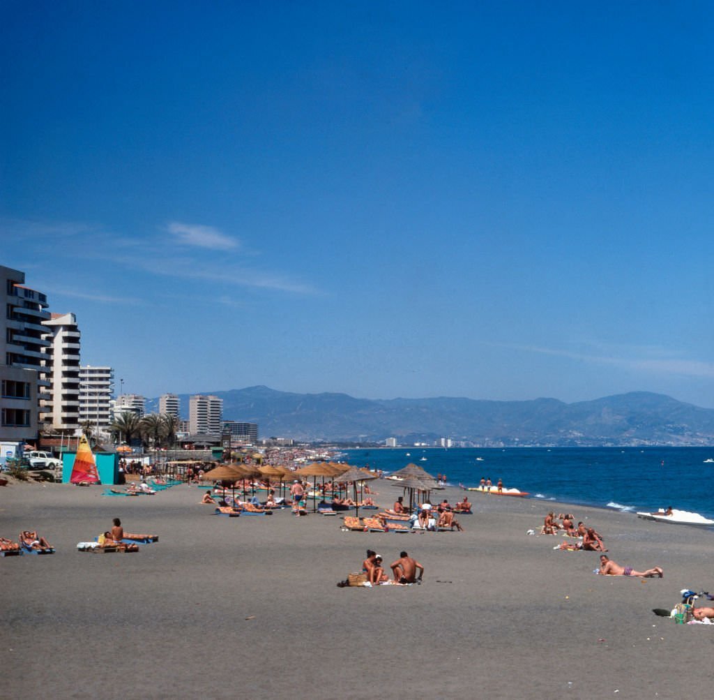 #83 Tourists at the beach of Torremolinos, Spain 1980s.