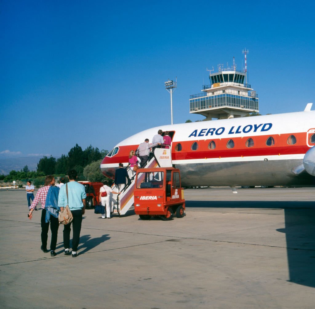 #85 Passengers enter a plane of Aero Lloyd at Almeria airport, Spain 1980s.