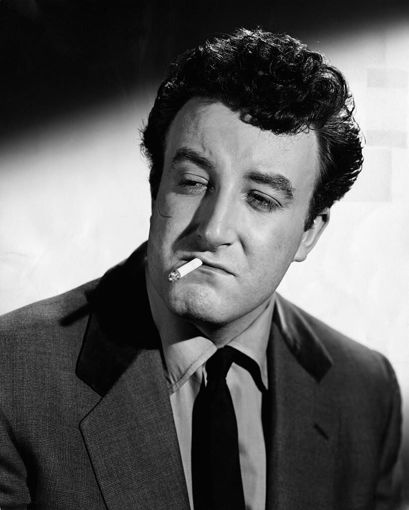Peter Sellers as he appears in the role of “Mr. Robinson,” alias Harry, a member of the “Guinness Gang