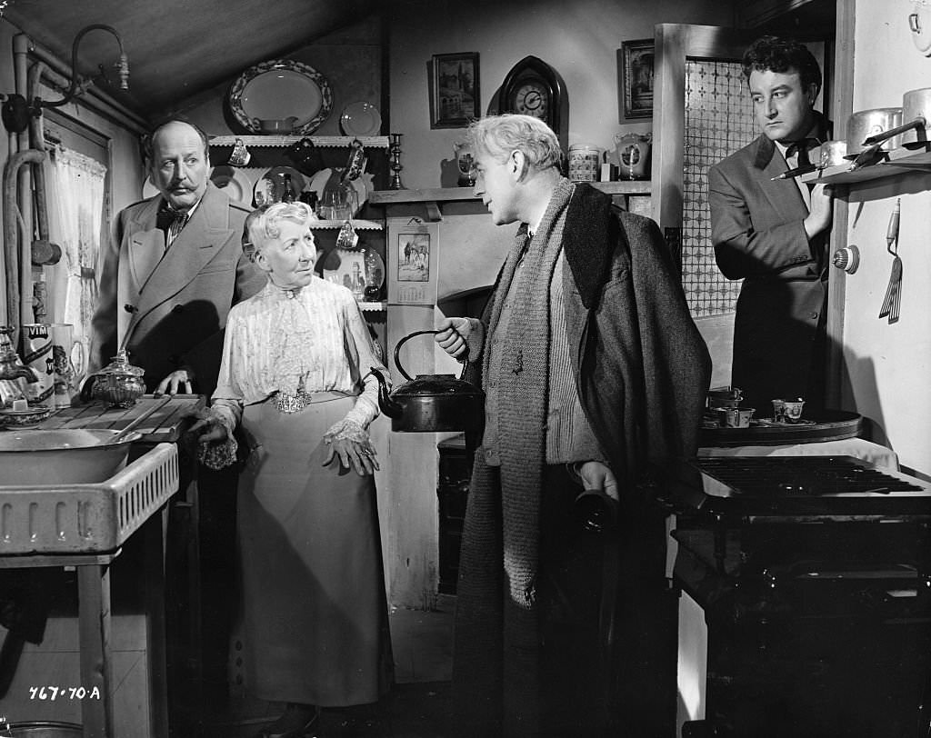 Professor Marcus (Alec Guinness) tries to convince Mrs. Wilberforce (Katie Johnson) that he had a good reason for participating in a robbery in the movie ‘Lady Killers’, 1955