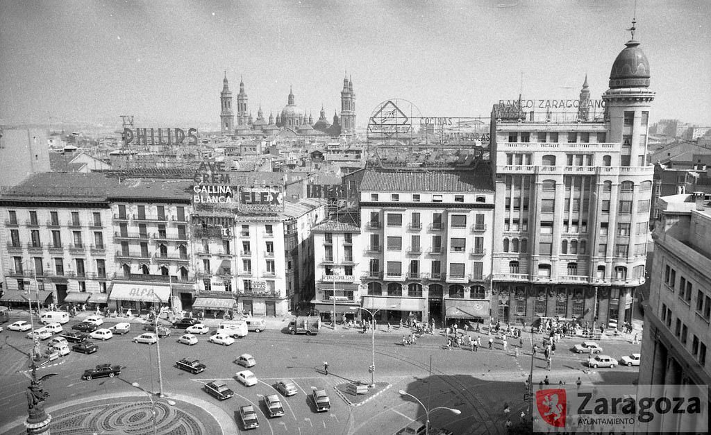 #85 View from above, panorama of the Plaza de España, with El Pilar in the background, well fitted as one more of the Coso’s commercial advertisements, 1970
