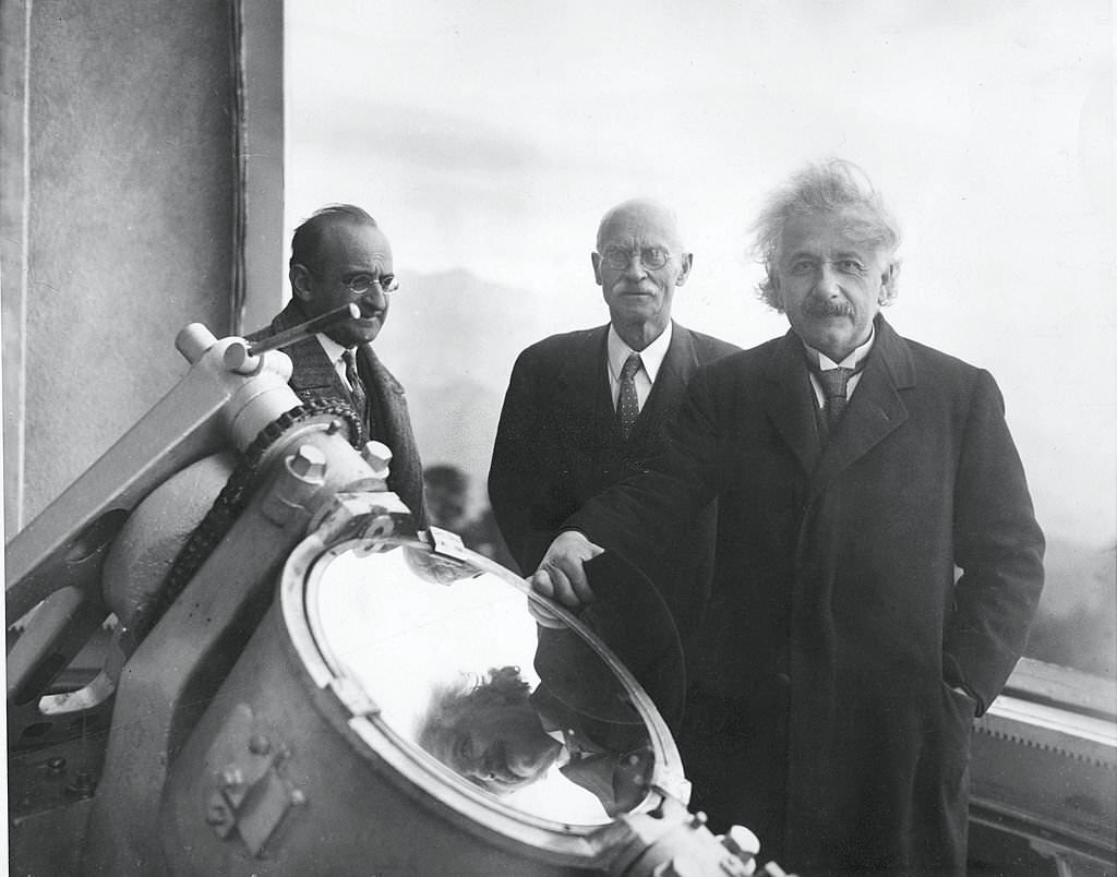 #103 Albert Einstein with American astronomer Charles E. St. John (center), and an unidentified man at the Mount Wilson Observatory in the Sierra Madre mountains, California, January 29, 1931.