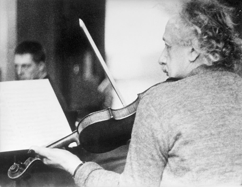 #11 Albert Einstein playing the violin at a chamber music rehearsal in Princeton.