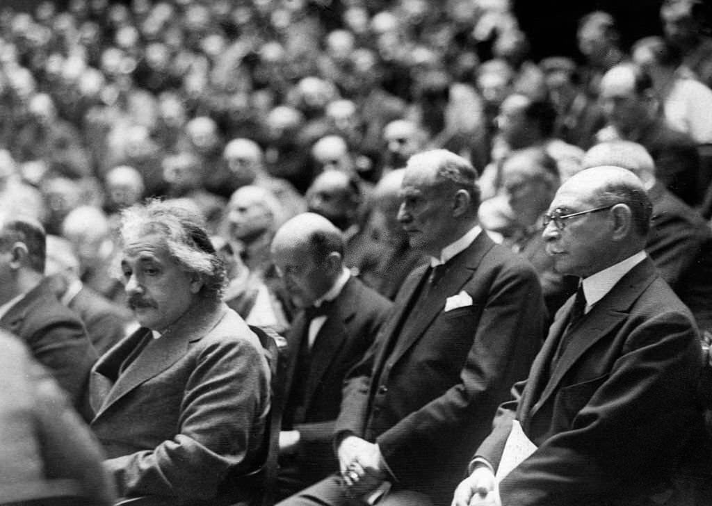 #21 Albert Einstein at the general assembly of the German Bunsen Society. Behind Einstein: Max Planck, 1928