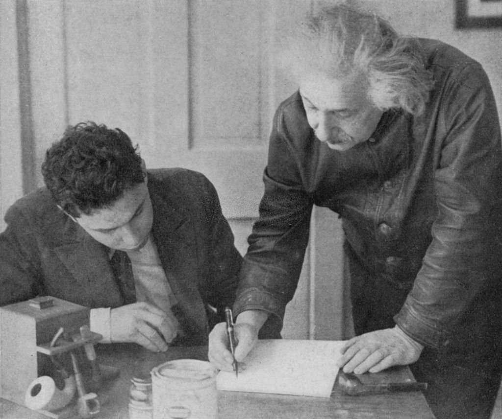 #80 Albert Einstein with a student.