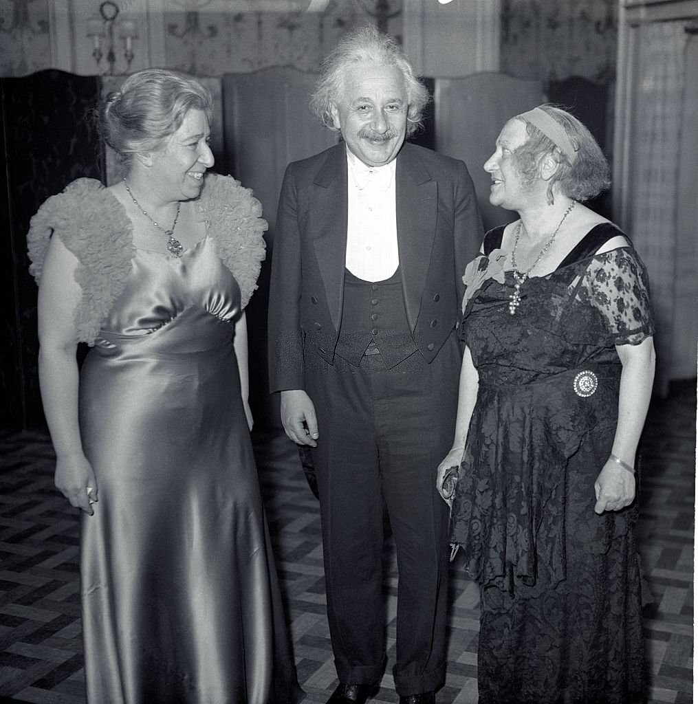 #93 Professor Albert Einstein with his wife, Elsa Einstein (right), and Mrs. Theresa M. Durlach, president of the World Peaceways Organization, at the dinner held in the Hotel Roosevelt in commemoration of the 100th anniversary of the birth of Alfred Bernard Nobel