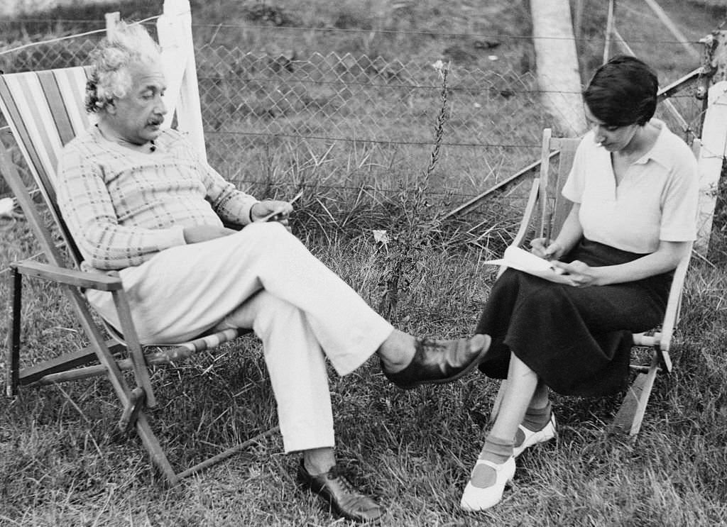 #95 Albert Einstein dictates to his secretary, long in his employ, Fräulein Helen Dukas, at Coq-sur-Mer, Belgium.
