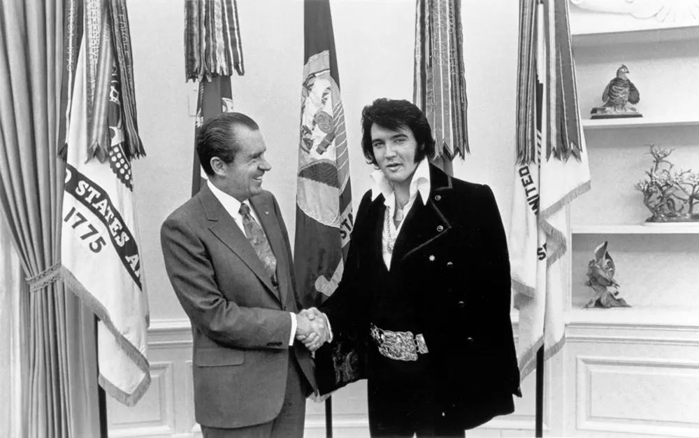 #12 Richard Nixon greets Elvis Presley at the White House, 1970.
