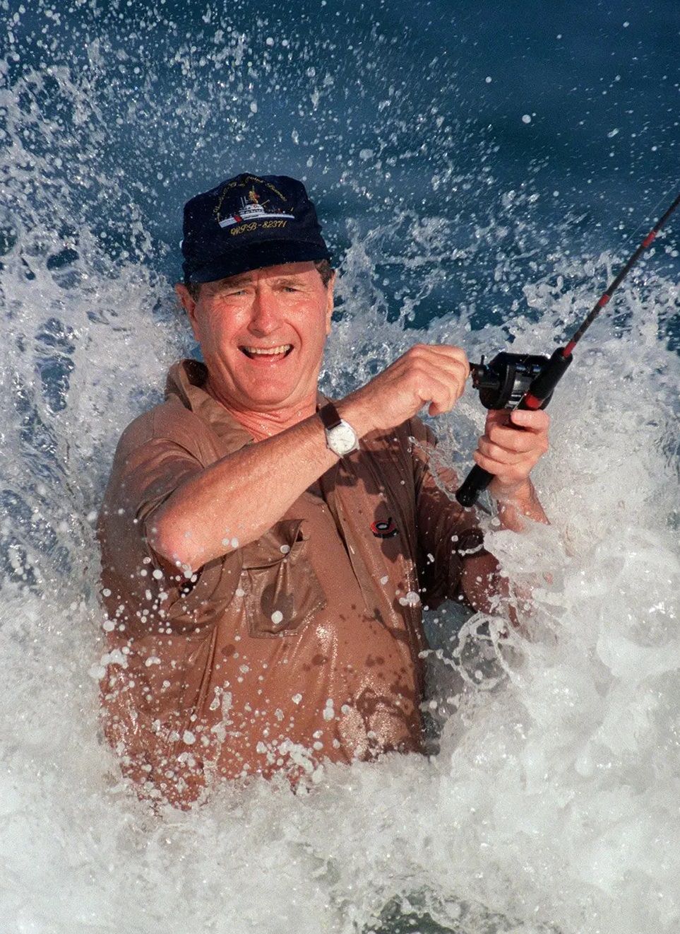 #16 George H.W. Bush fishes in the surf in Florida, 1988.