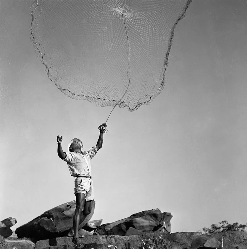 #20 A fisherman casts his net.