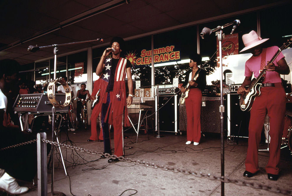 #20 A band performs at the Lake Meadows Shopping Center in Chicago, in August of 1973.