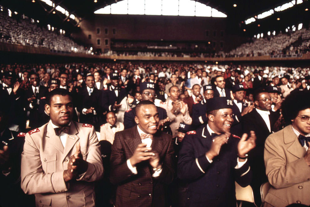 #30 A portion of a crowd of some 10,000 Muslims applauds Elijah Muhammad during the delivery of his Savior’s Day Message in Chicago, in March 1974.