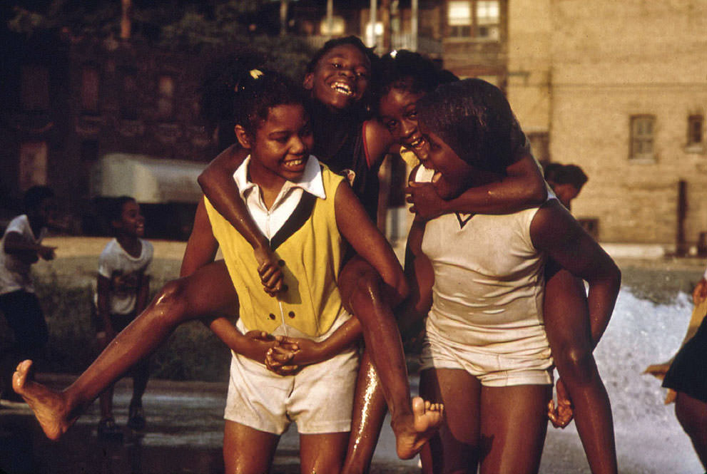 #34 Youngsters cool off with fire hydrant water in the Woodlawn Community, June 1973.