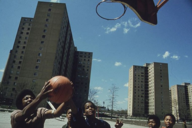 #60 Black youths play basketball at Stateway Gardens’ Highrise Housing Project on Chicago’s South Side.