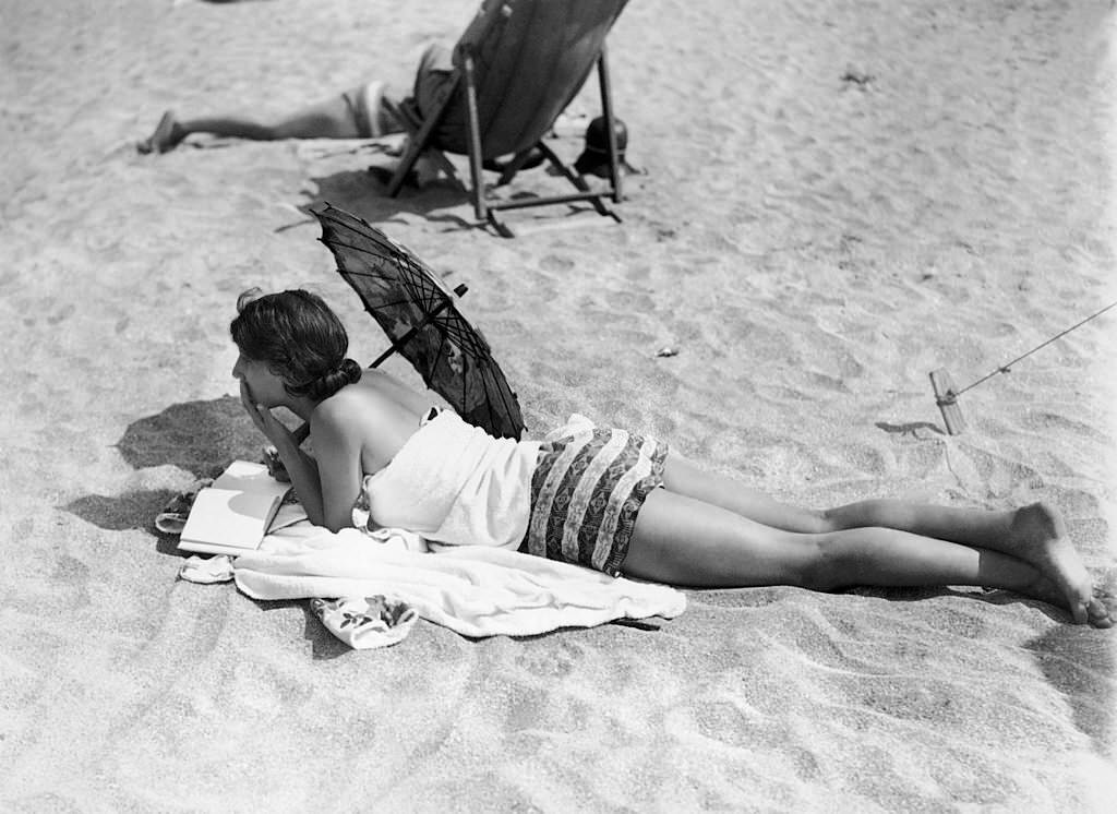 #14 A young woman reading on the beach in Deauville, 1920