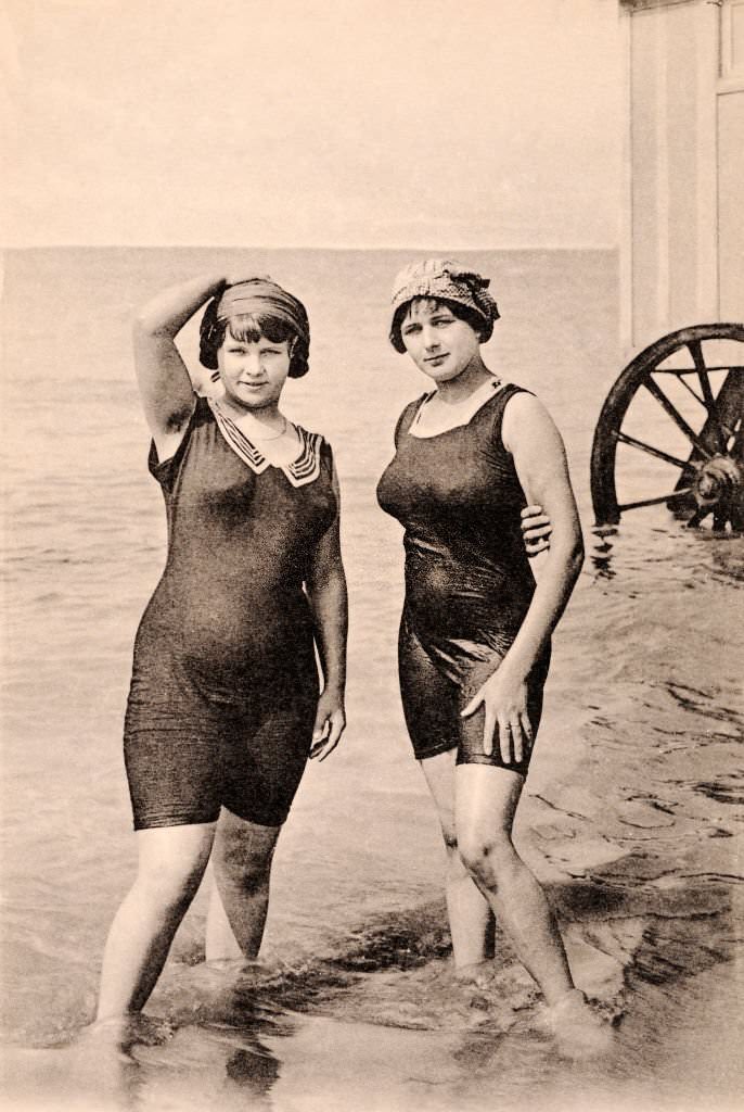 #16 Two young women wearing bathing costumes with a bath cart behind, 1920.