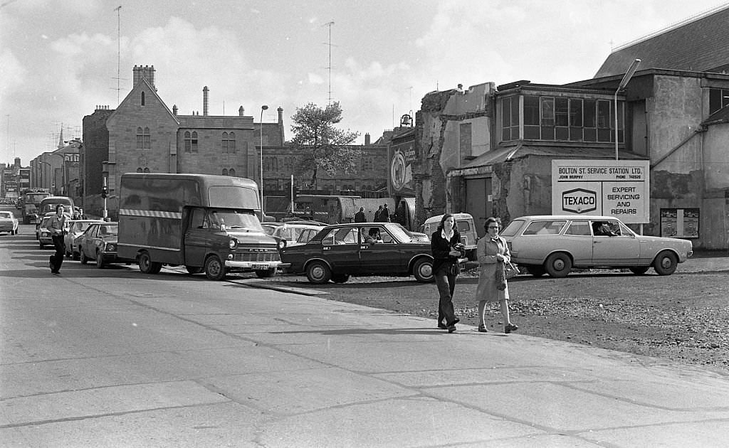#103 Street scene, people queuing for petrol, 1975