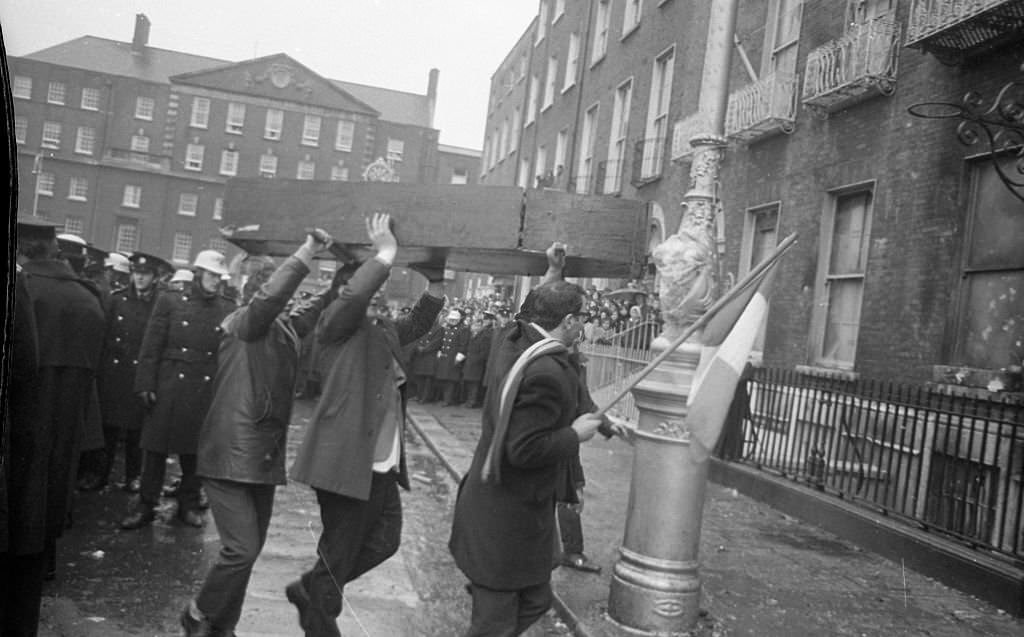 #38 Protestors brining a mock coffin March to the burnt-out British Embassy on Merrion Sq that had been destroyed in the proterst the previous night, 1972