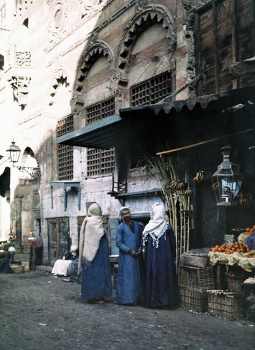 #2 Man and two women stand at his homegrown fruit booth in Cairo.