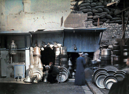 #36 Men sitting at a shop at a bazaar.