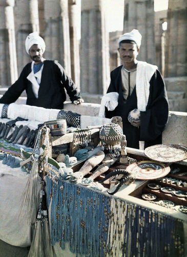 #46 Two men stand in front of souvenir booths in the street of Cairo.