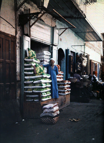 #7 Man standing outside of his quilt and cushion shop in old Cairo.