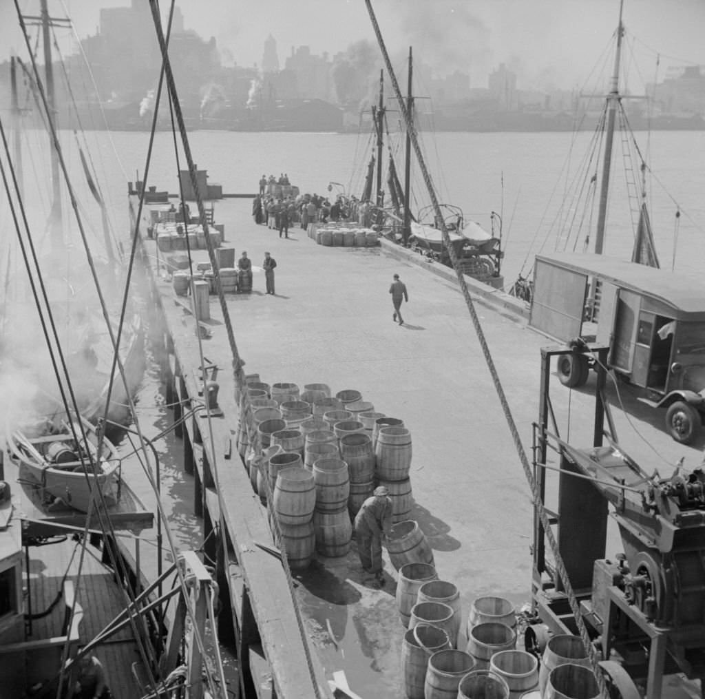 #145 A scene at the Fulton fish market showing the dock where New England fishing boats unload their cargo.