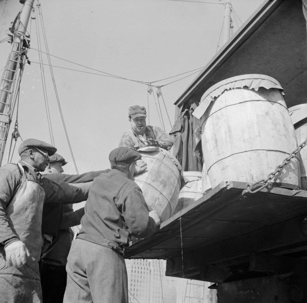 #29 Dock worker at the Fulton fish market loading fish that have been caught in Gloucester, 1930s