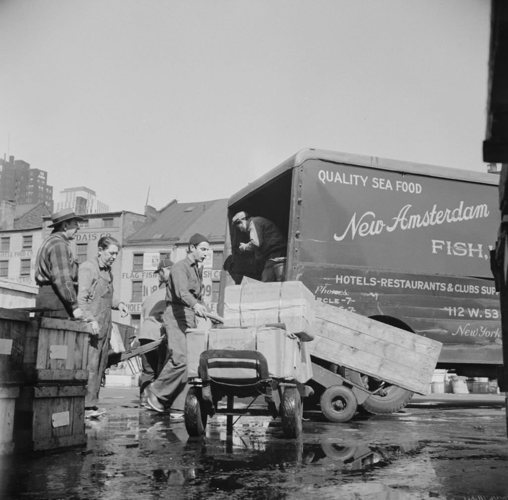 #43 Loading boxes of fish to be shipped to hotels and restaurants at the Fulton fish market, 1934