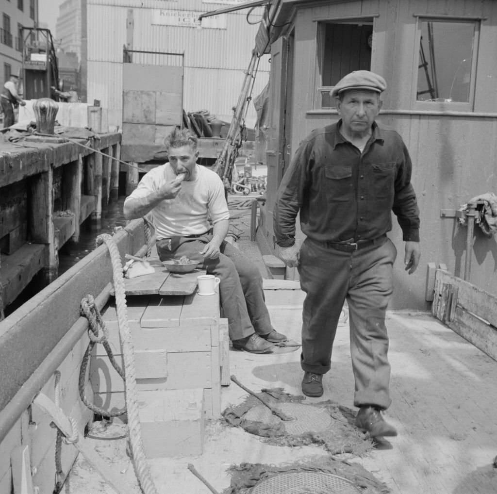 #49 New England fisherman aboard their ship at Fulton fish market, 1930s