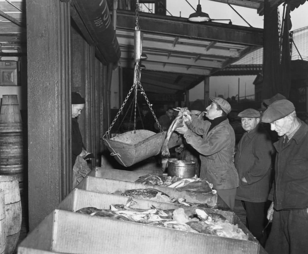 #79 Fulton Fish Market fishmongers at work in the early hours of the morning, New York, 1949.